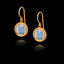 Gold earrings with white translucent gemstones on a black background