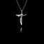 An oxidised silver cross pendant featuring on a black background.