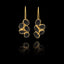 Gold earrings with black gemstones on a black background