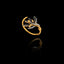 Gold and silver olive branch ring on a black background