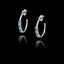Silver hoop earrings with sapphire CZ and zircon gemstones on a black background