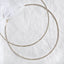 Handmade sterling silver Stefana with gold-plated wire details and white crystals on a white textured background.