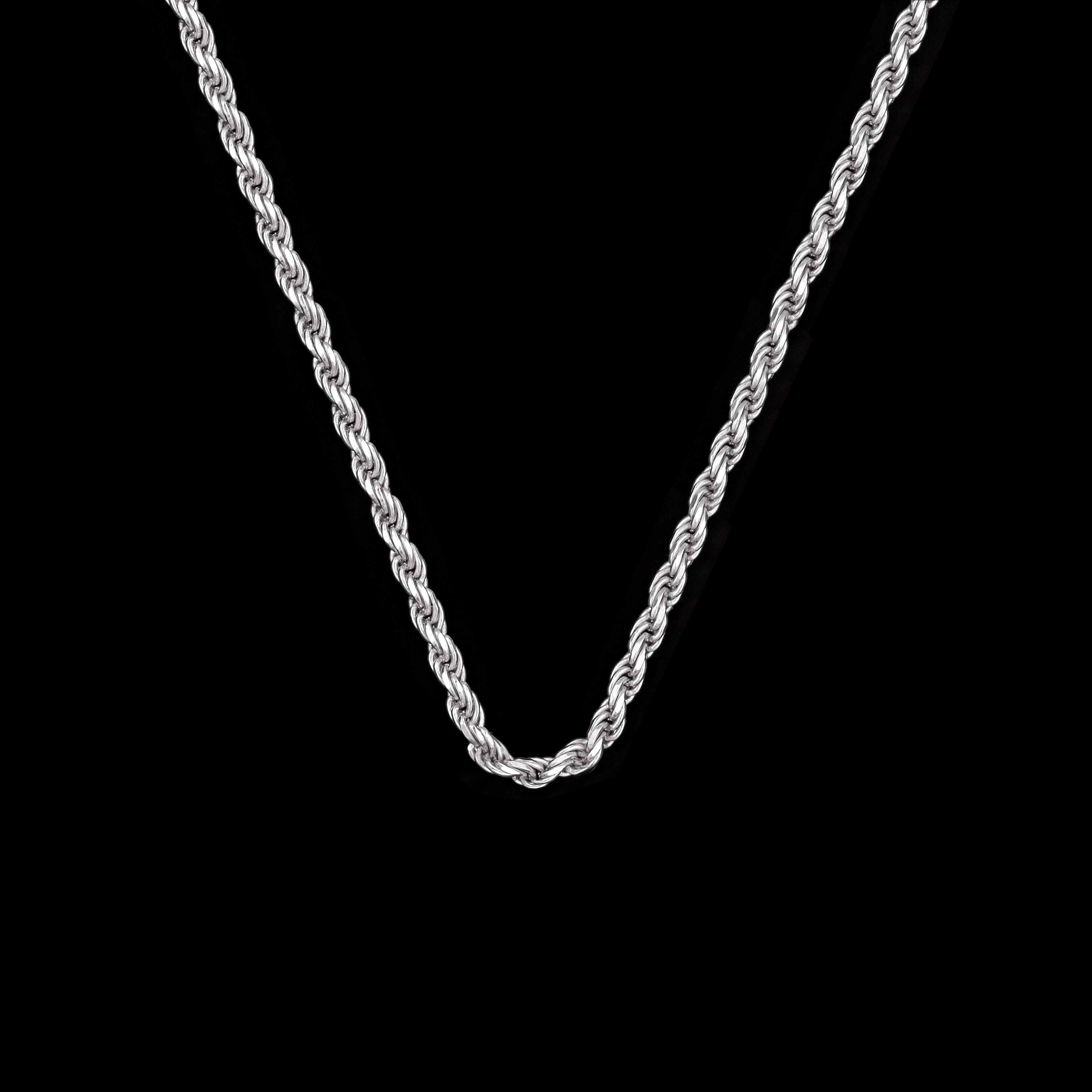 Silver rope chain necklace on a black background