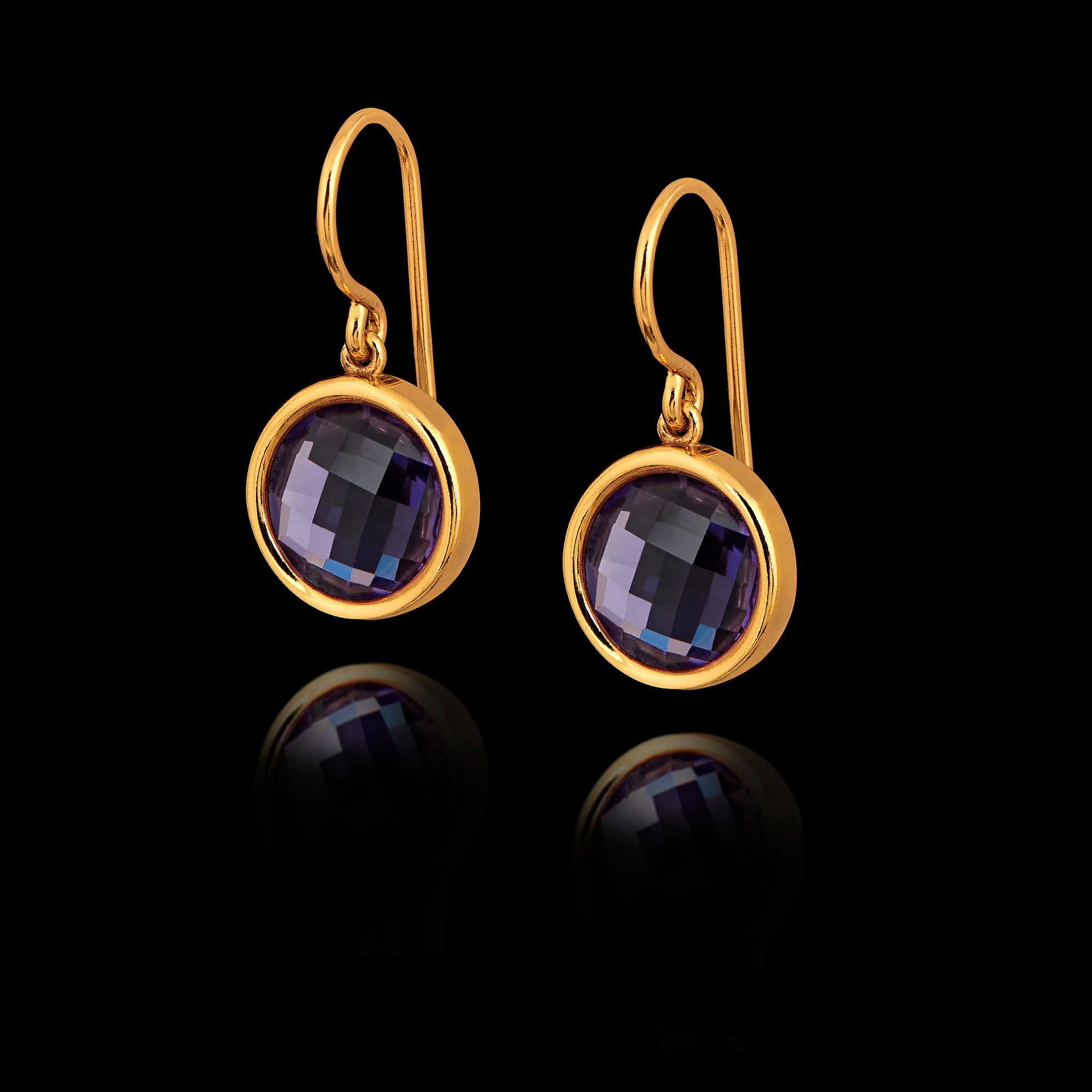 Gold earrings with purple gemstones on a black background