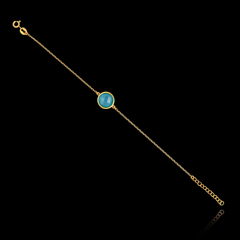 Full view of the gold plated 925 sterling silver chain bracelet featuring a round turquoise gemstone and an adjustable extender chain.
