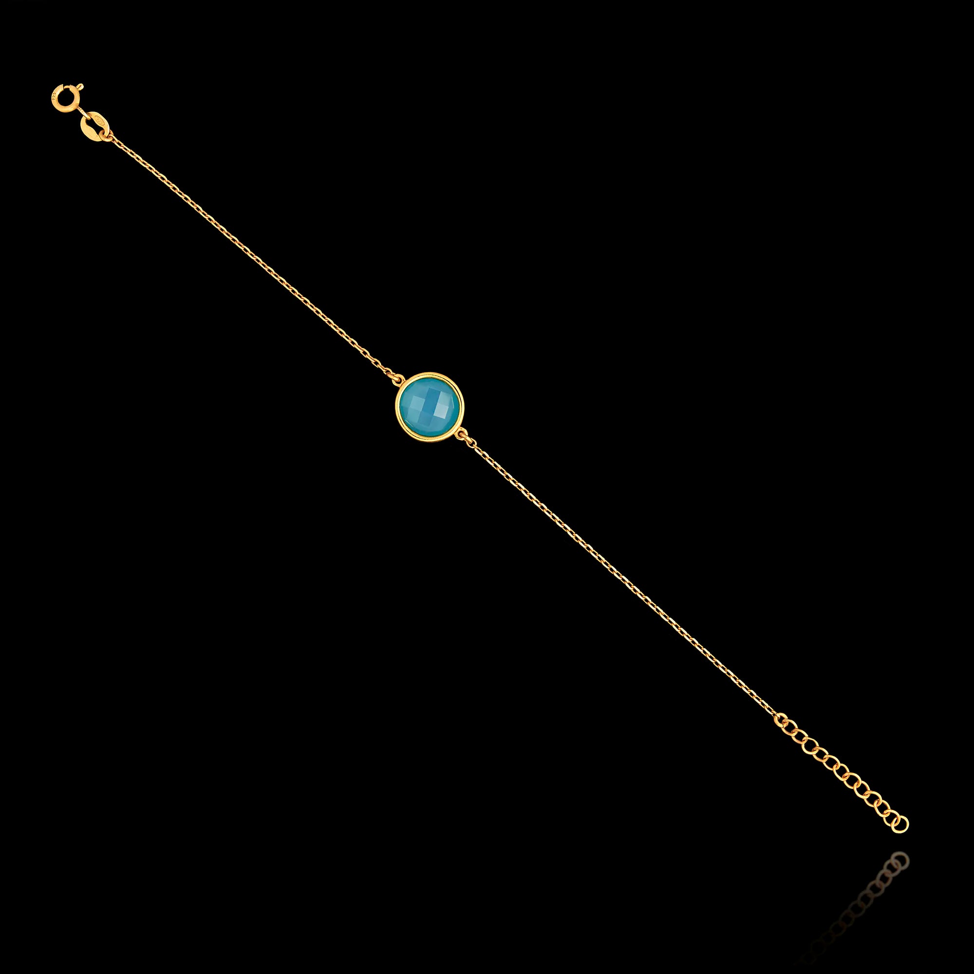 Full view of the gold plated 925 sterling silver chain bracelet featuring a round turquoise gemstone and an adjustable extender chain.