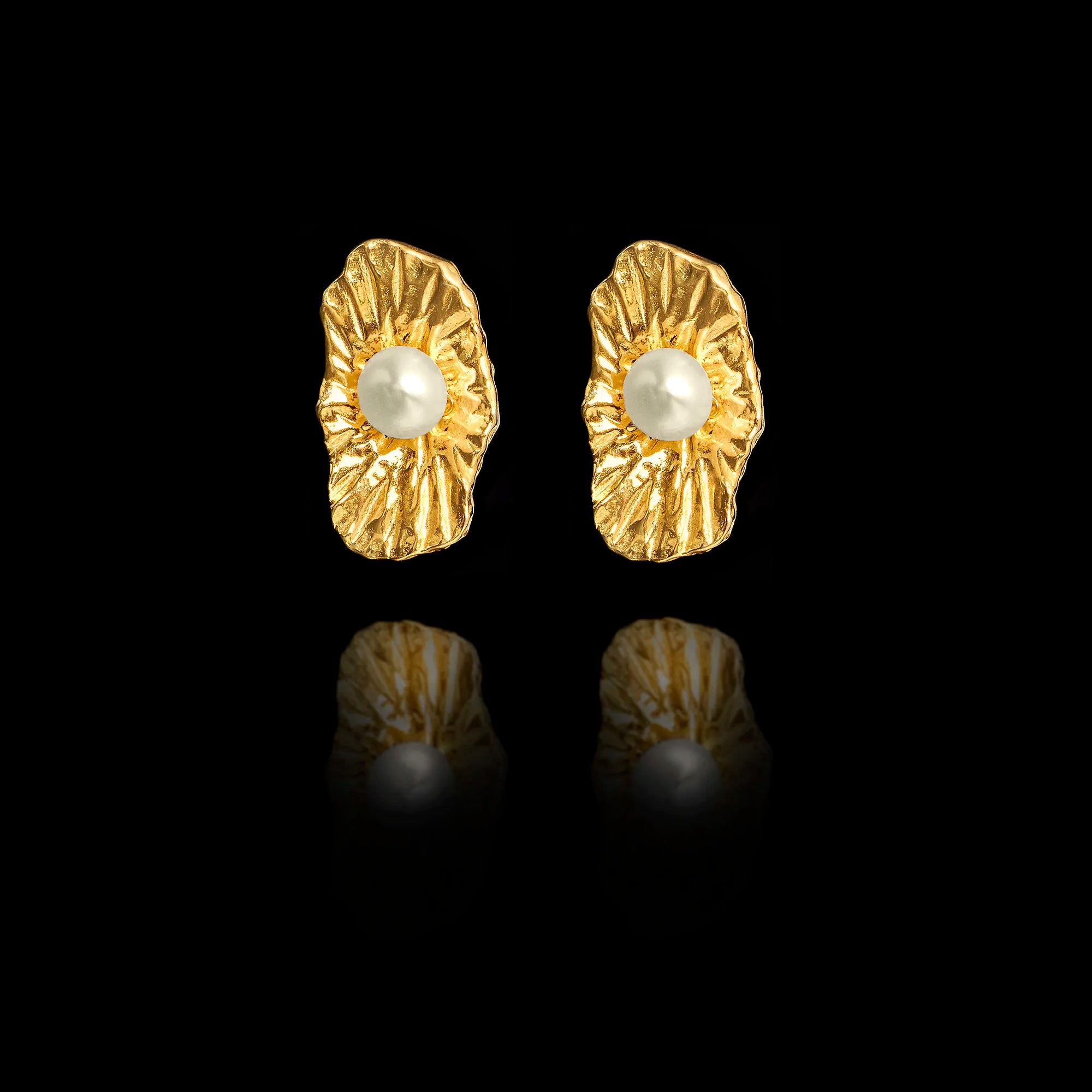 Front view of organic-shaped gold stud earrings with a wavy shell-like texture and a central white pearl. Main image