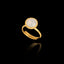 Gold plated 925 sterling silver adjustable ring featuring a round faceted semi-translucent white synthetic gemstone in a bezel setting.