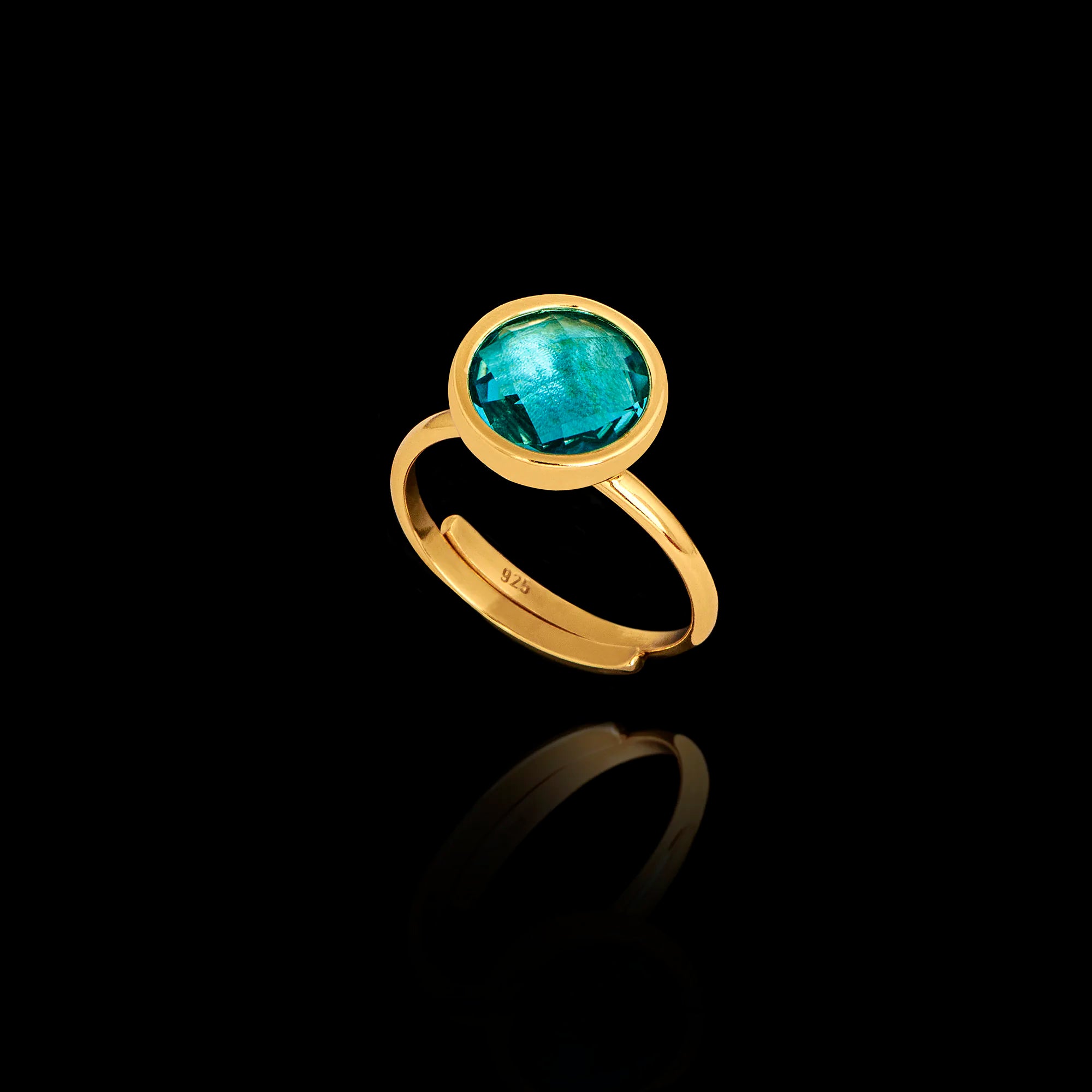 Gold plated 925 sterling silver adjustable ring featuring a round faceted synthetic aquamarine gemstone in a bezel setting.