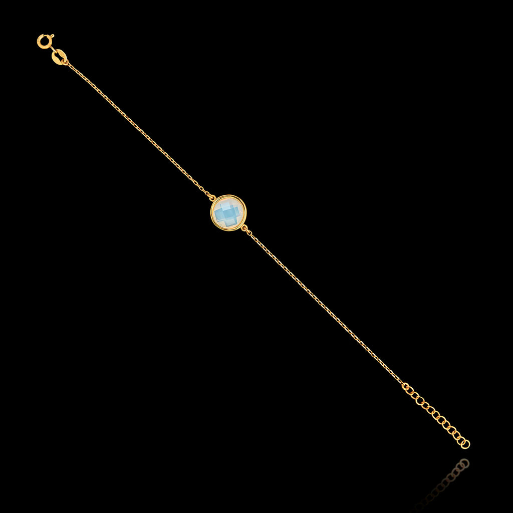 Full view of the gold plated 925 sterling silver chain bracelet featuring a round semi-translucent white gemstone and an adjustable extender chain.