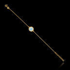 Full view of the gold plated 925 sterling silver chain bracelet featuring a round semi-translucent white gemstone and an adjustable extender chain.