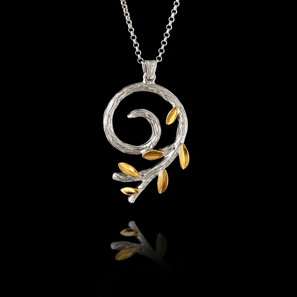 a silver spiral olive branch pendant on a chain, featuring a rhodium-plated stem and gold-plated leaves.