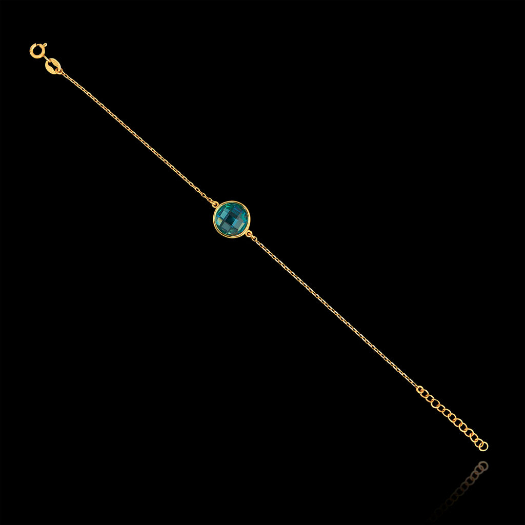 Full view of the gold plated 925 sterling silver chain bracelet featuring a round faceted synthetic emerald green gemstone and an adjustable extender chain.