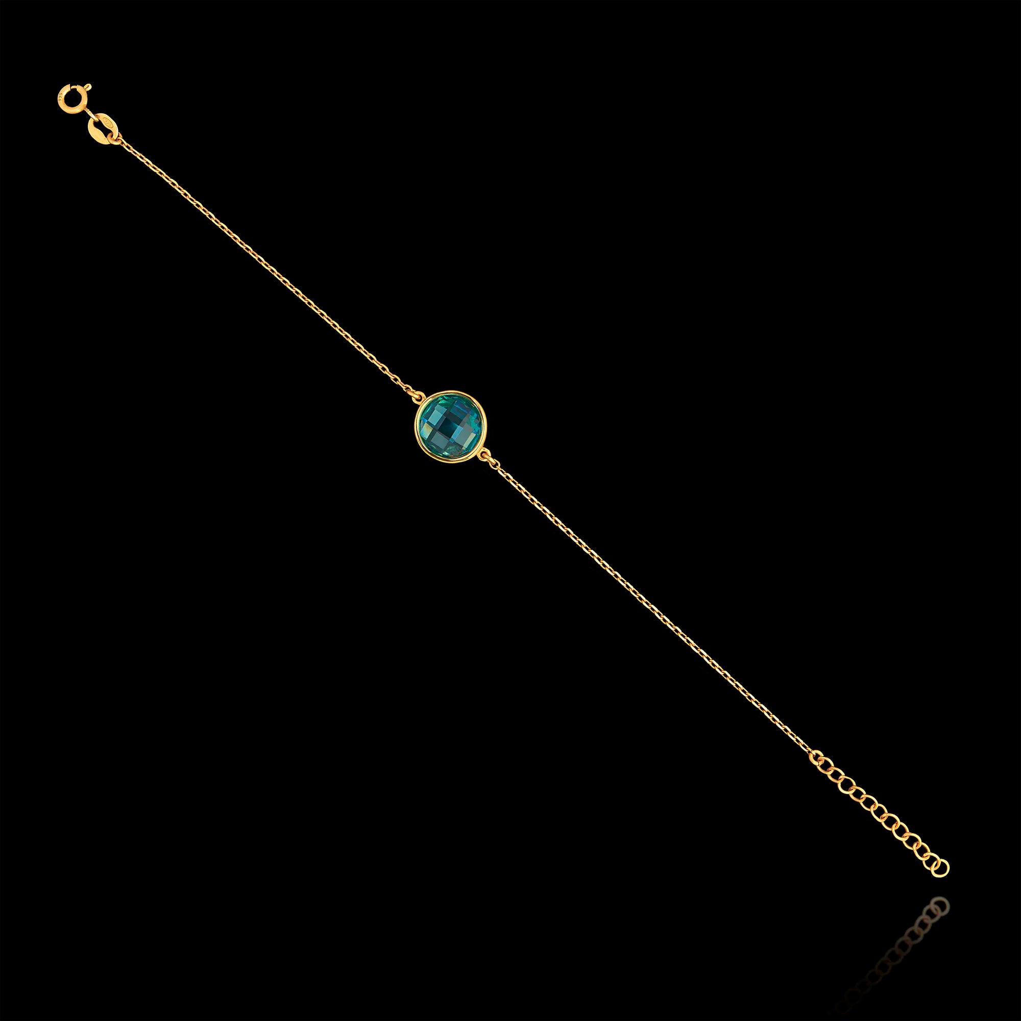 Full view of the gold plated 925 sterling silver chain bracelet featuring a round faceted synthetic emerald green gemstone and an adjustable extender chain.