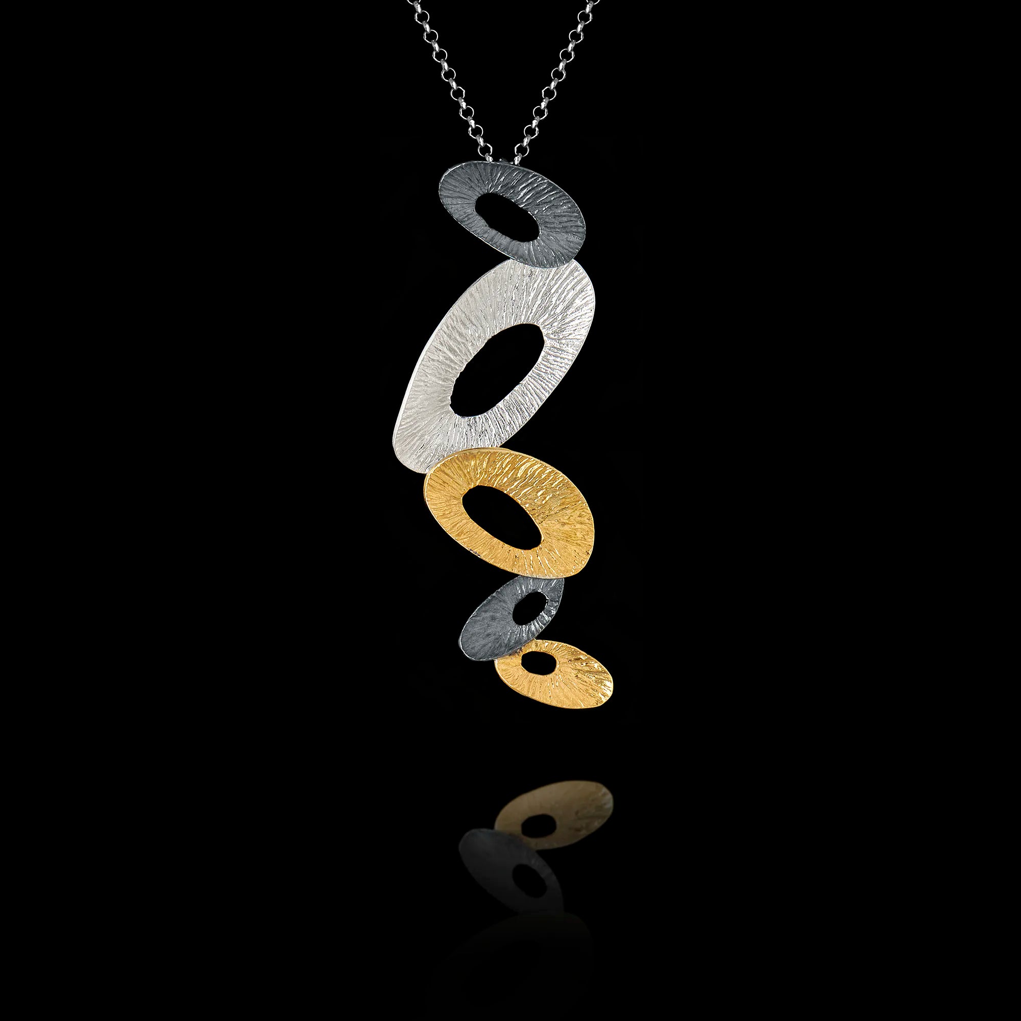 Necklace with circular pendant on a black background Main image
