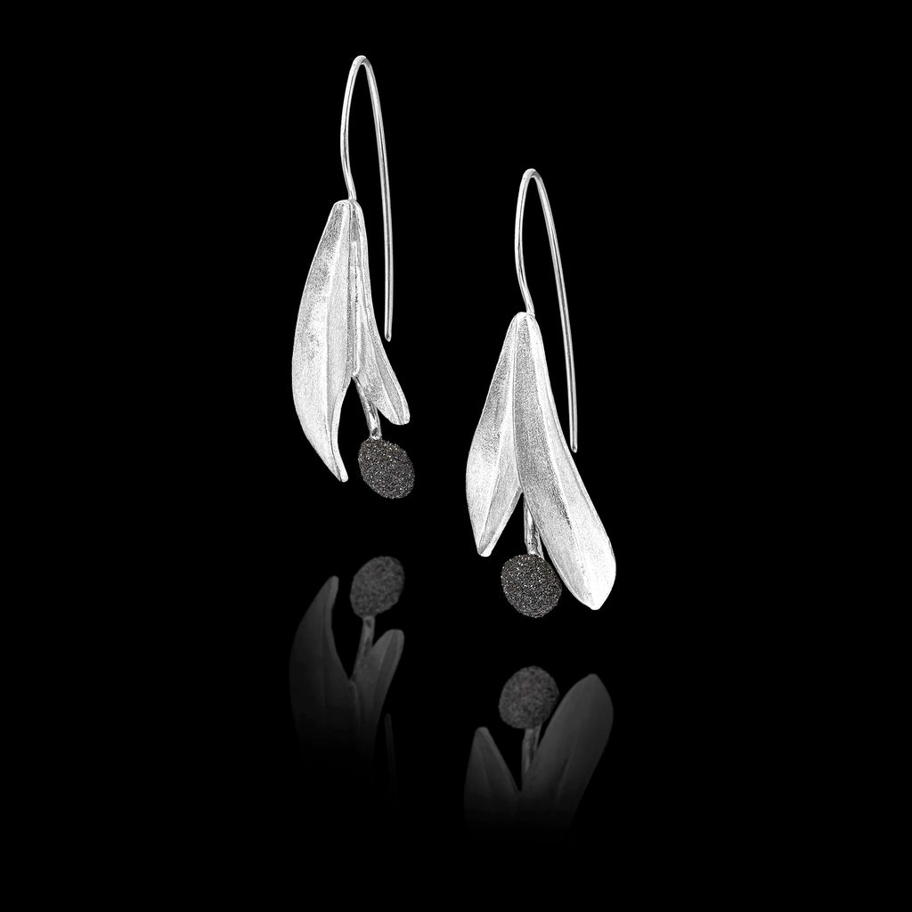 Side view of the silver leaf earrings showing the textured round gemstone and long hook fastening.