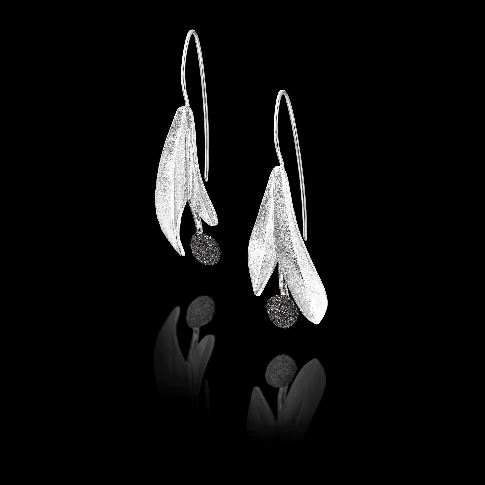 Side view of the silver leaf earrings showing the textured round gemstone and long hook fastening.