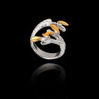 Silver and gold ring featuring a detailed branch design with textured olive leaves on a black background
