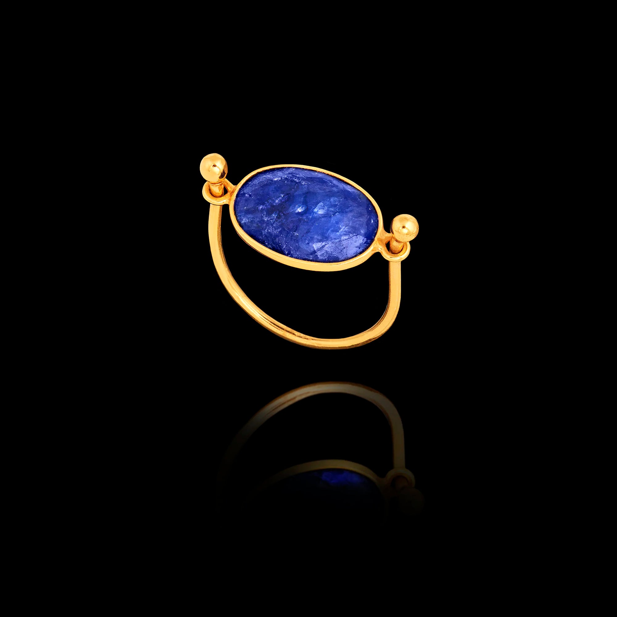 Gold ring featuring an oval lapis lazuli gemstone on a black background