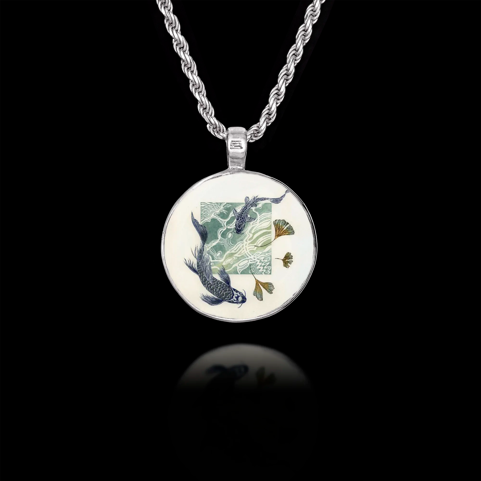 Round 925 sterling silver pendant featuring blue koi fish swimming in stylized water with golden ginkgo leaves. Main image