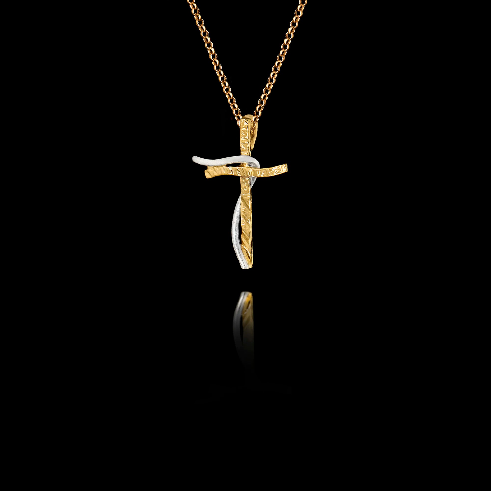 Side angle view of a handcrafted 925 sterling silver two-tone cross pendant showing the interplay between the gold-plated textured cross and the rhodium-plated curved accent, on a gold chain.