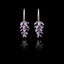 Front view of handcrafted silver earrings shaped like lavender sprigs with oxidized silver stems and purple enamel buds.