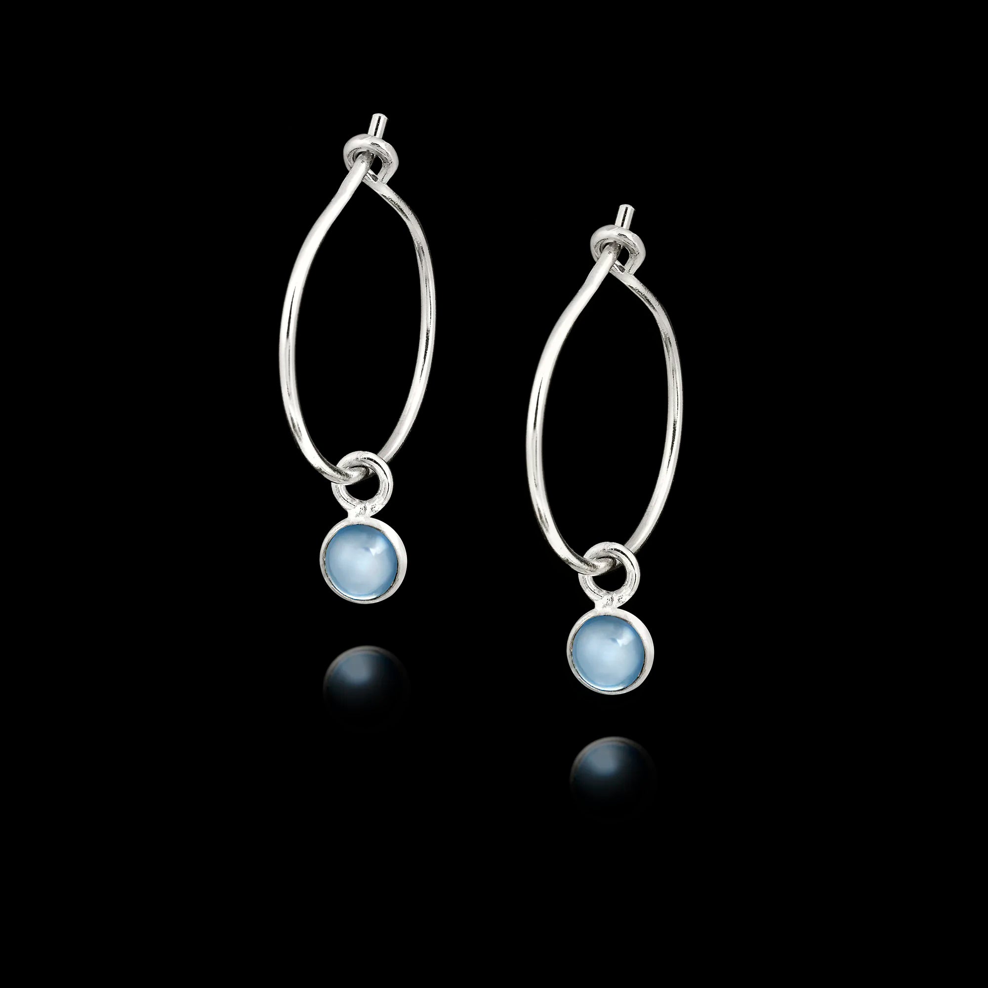 Pair of 925 sterling silver teardrop hook earrings featuring small round, slightly translucent light blue aquamarine gemstones in silver bezel settings. Main image