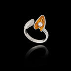 Perspective view of the adjustable silver shell ring highlighting the textured surfaces and the pearl nestled in the gold-plated mussel shell.
