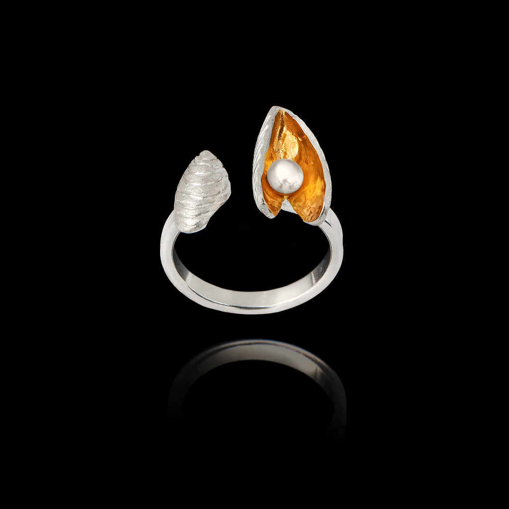 Front view of an adjustable silver ring featuring a textured shell and an open mussel shell with a gold interior and a pearl.