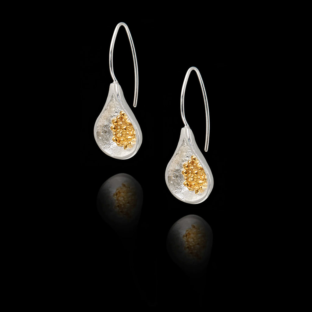 Front view of silver teardrop earrings with  gold cluster of fig seeds inside.