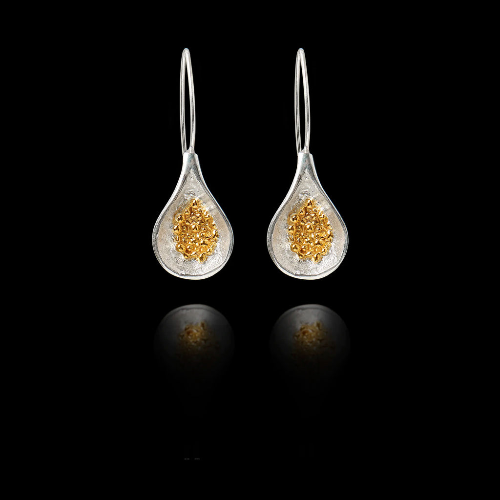 Front view of silver teardrop earrings with  gold cluster of fig seeds inside.