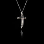 Side angle view of a handcrafted 925 sterling silver modern cross pendant showing the layered parallel bars and curved horizontal element with oxidised and rhodium-plated finish on a silver chain.