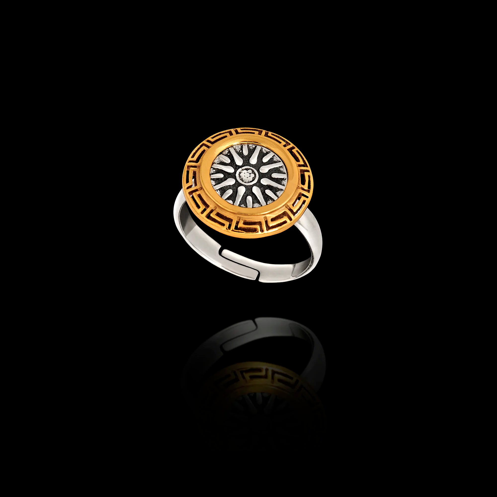 Adjustable ring featuring an oxidized silver Vergina Sun center surrounded by a gold-plated Meander (Greek Key) frame.