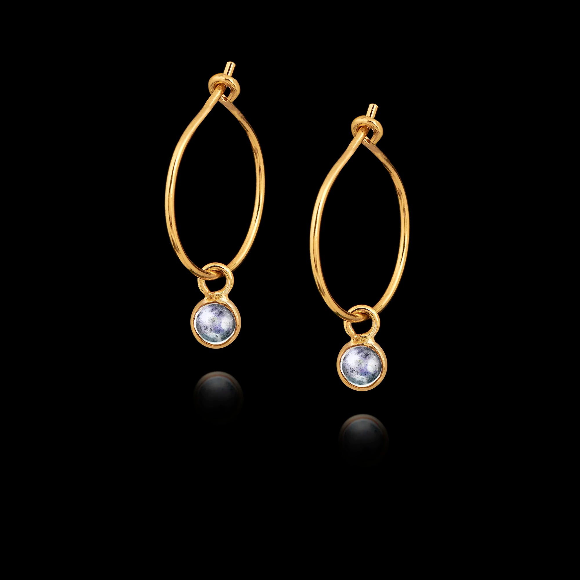 Gold hoop earrings with moonstone gemstones on a black background Main image
