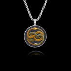 Round 925 sterling silver pendant featuring the Auryn symbol of two intertwined snakes (gold and silver) biting each other's tails.