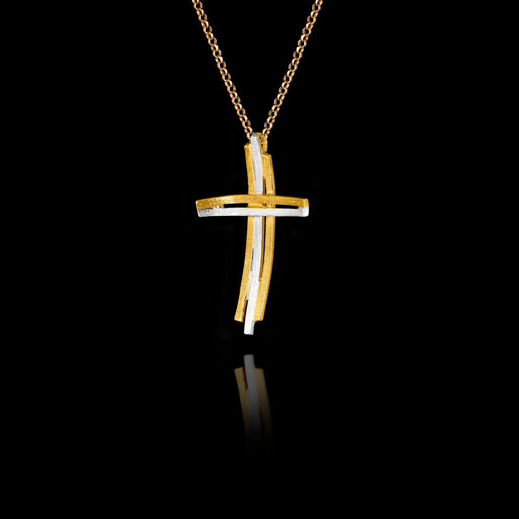 Side angle view of a handcrafted 925 sterling silver modern two-tone cross pendant showing the layered gold-plated and rhodium-plated bars with curved horizontal element on a gold chain.