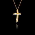 Side angle view of a handcrafted 925 sterling silver modern two-tone cross pendant showing the layered gold-plated and rhodium-plated bars with curved horizontal element on a gold chain.