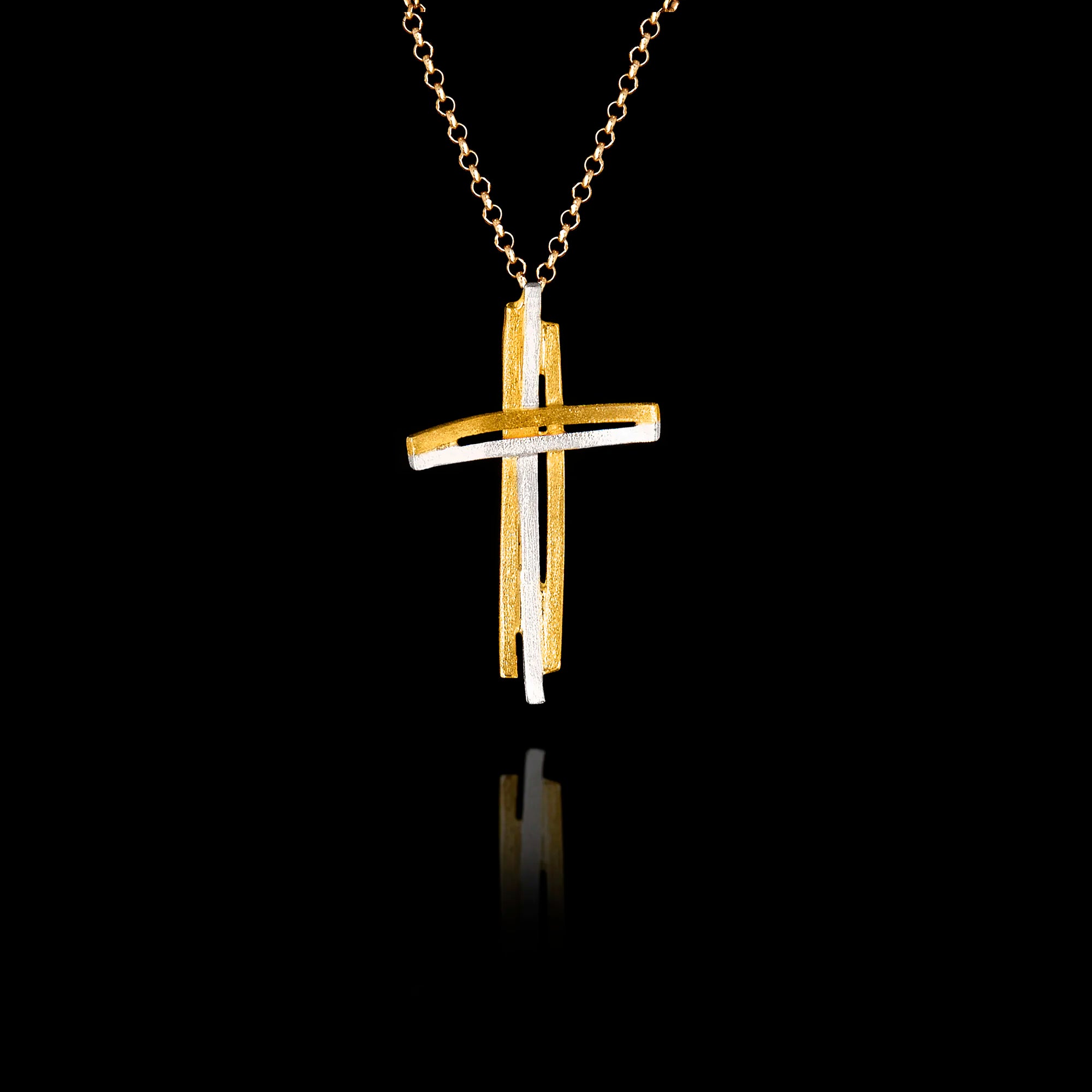 Handcrafted 925 sterling silver modern cross pendant with sculptural double-bar design in gold and rhodium-plated finish, hanging on a gold chain against a black background. Main image