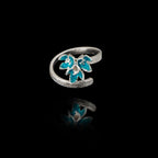 Top view of the triple-flower ring showing the textured silver vine band and the detailed blue enamel on the blossoms.