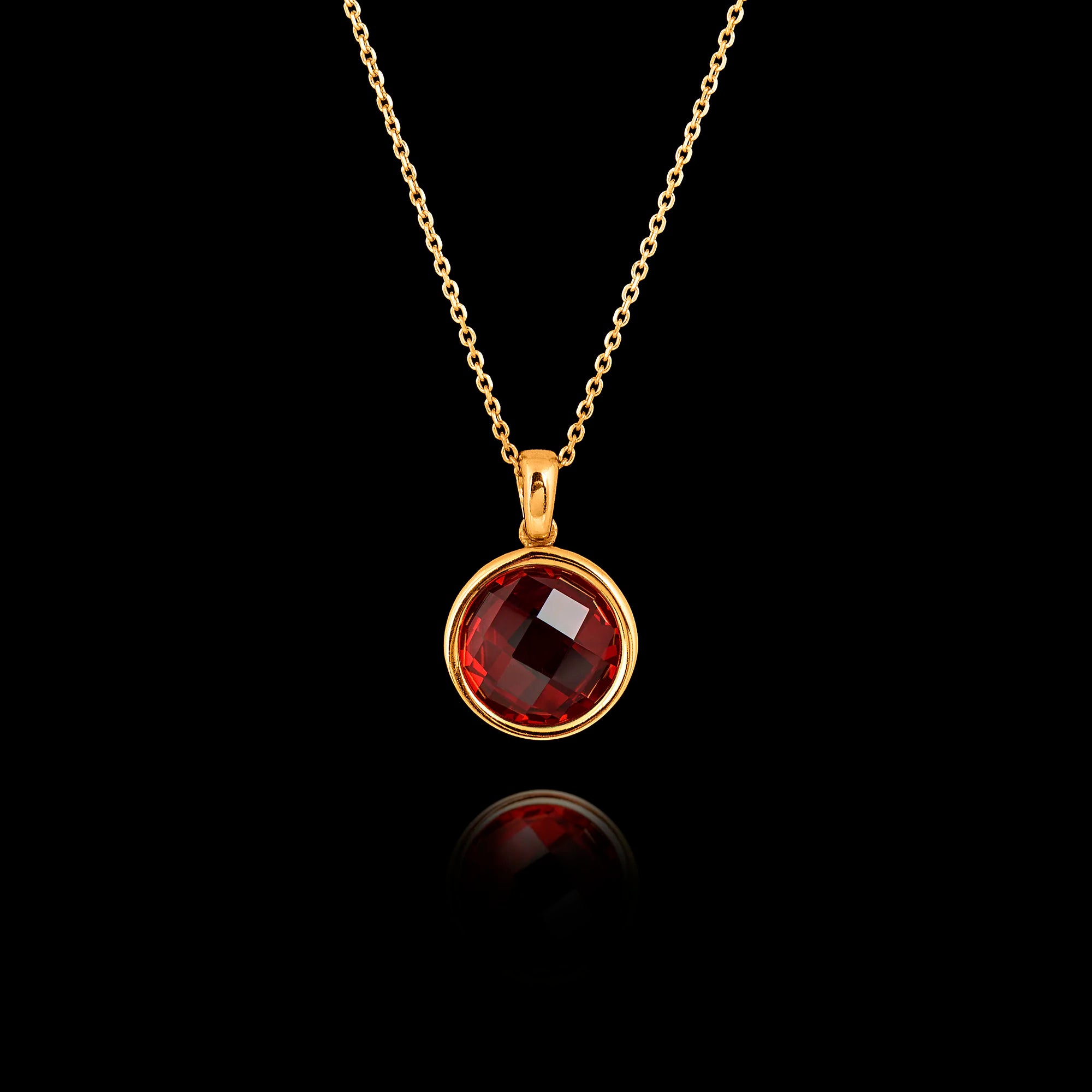 Gold plated 925 sterling silver pendant necklace featuring a round 1cm faceted synthetic ruby gemstone on an adjustable chain.