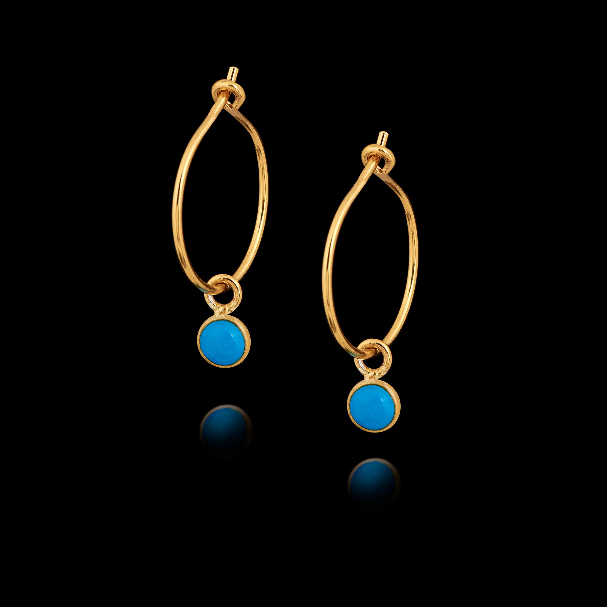 Gold hoop earrings with turquoise gemstones on a black background Main image