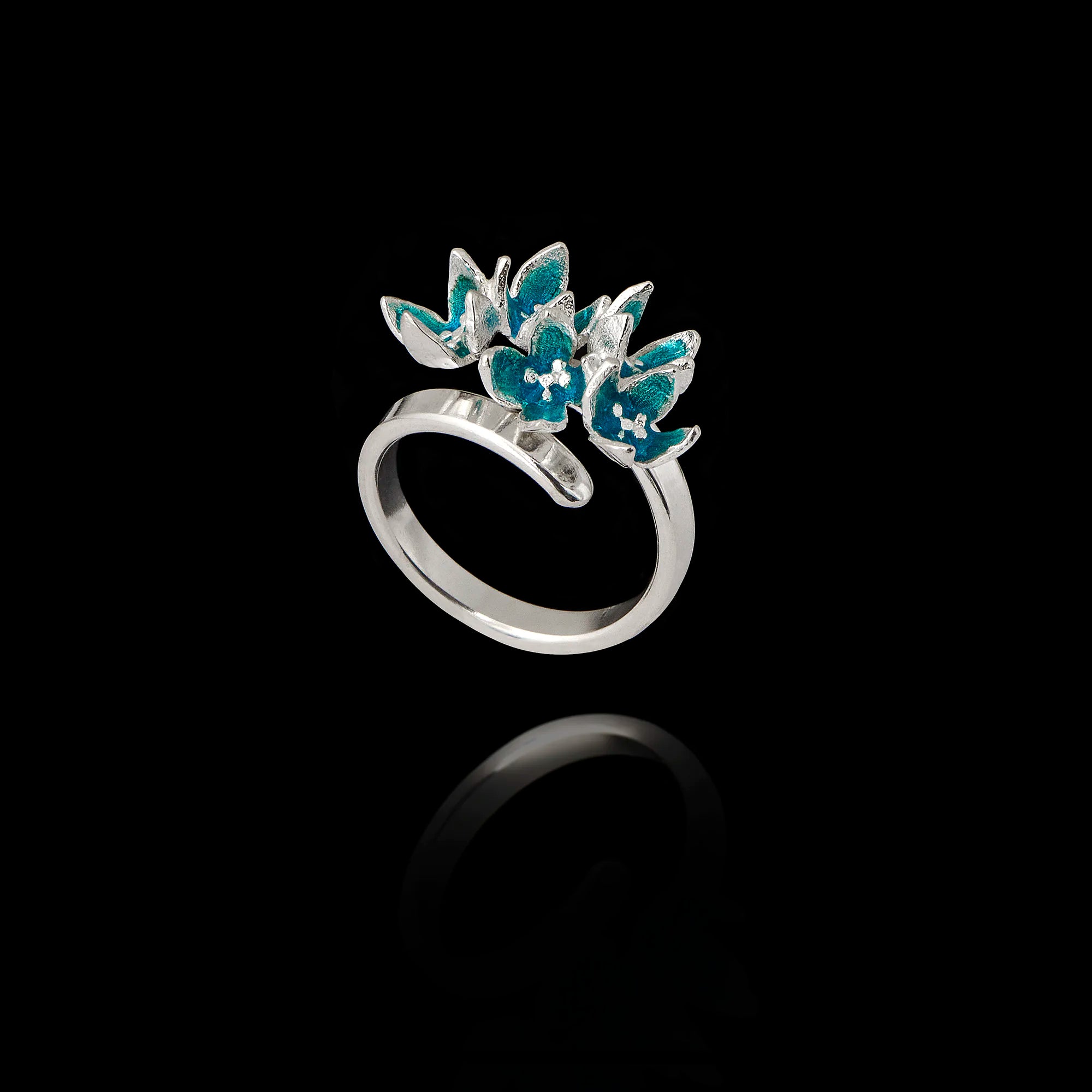 Angled view of an adjustable 925 sterling silver ring featuring a cluster of five flowers with bright turquoise enamel petals. Main image