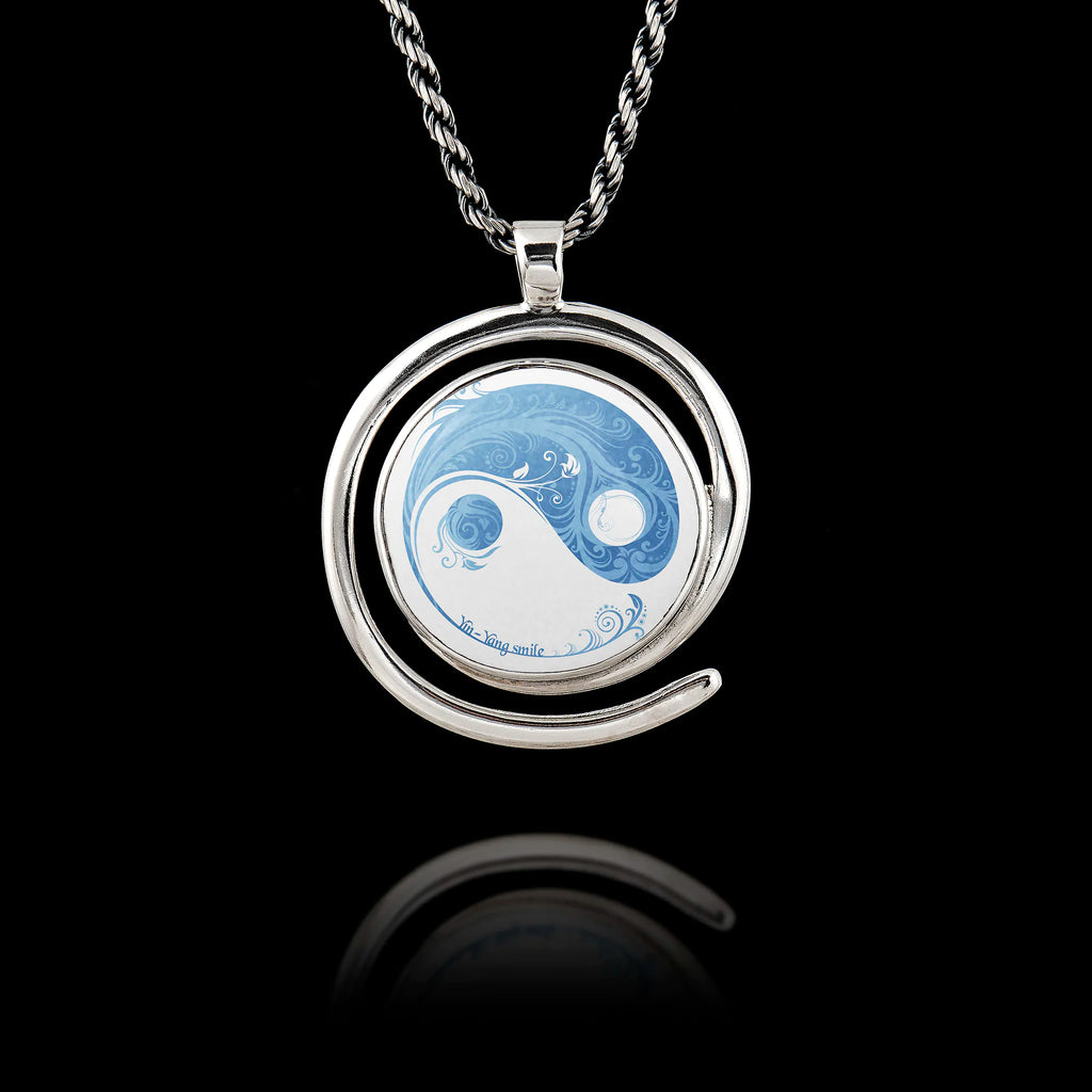 Round 925 sterling silver pendant with a spiral frame featuring a blue and white floral Yin Yang design.