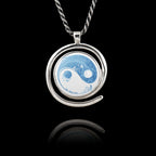Round 925 sterling silver pendant with a spiral frame featuring a blue and white floral Yin Yang design.