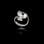 Top view of an adjustable silver ring designed as a flower with textured petals and a pearl in the center.