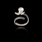 Perspective view of an adjustable silver ring designed as a flower with textured petals and a pearl in the center.