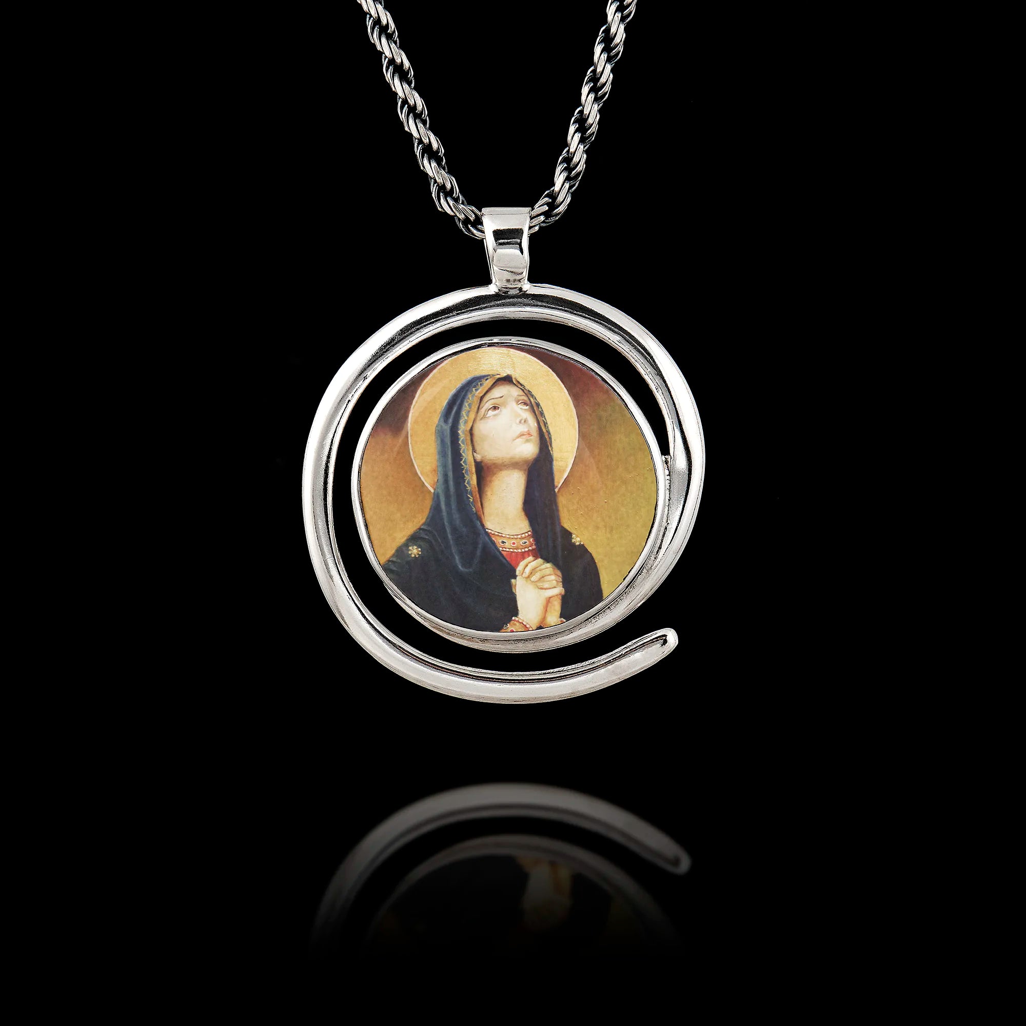 Round 925 sterling silver pendant with a spiral frame featuring a classic painting of the Virgin Mary in prayer. Main image