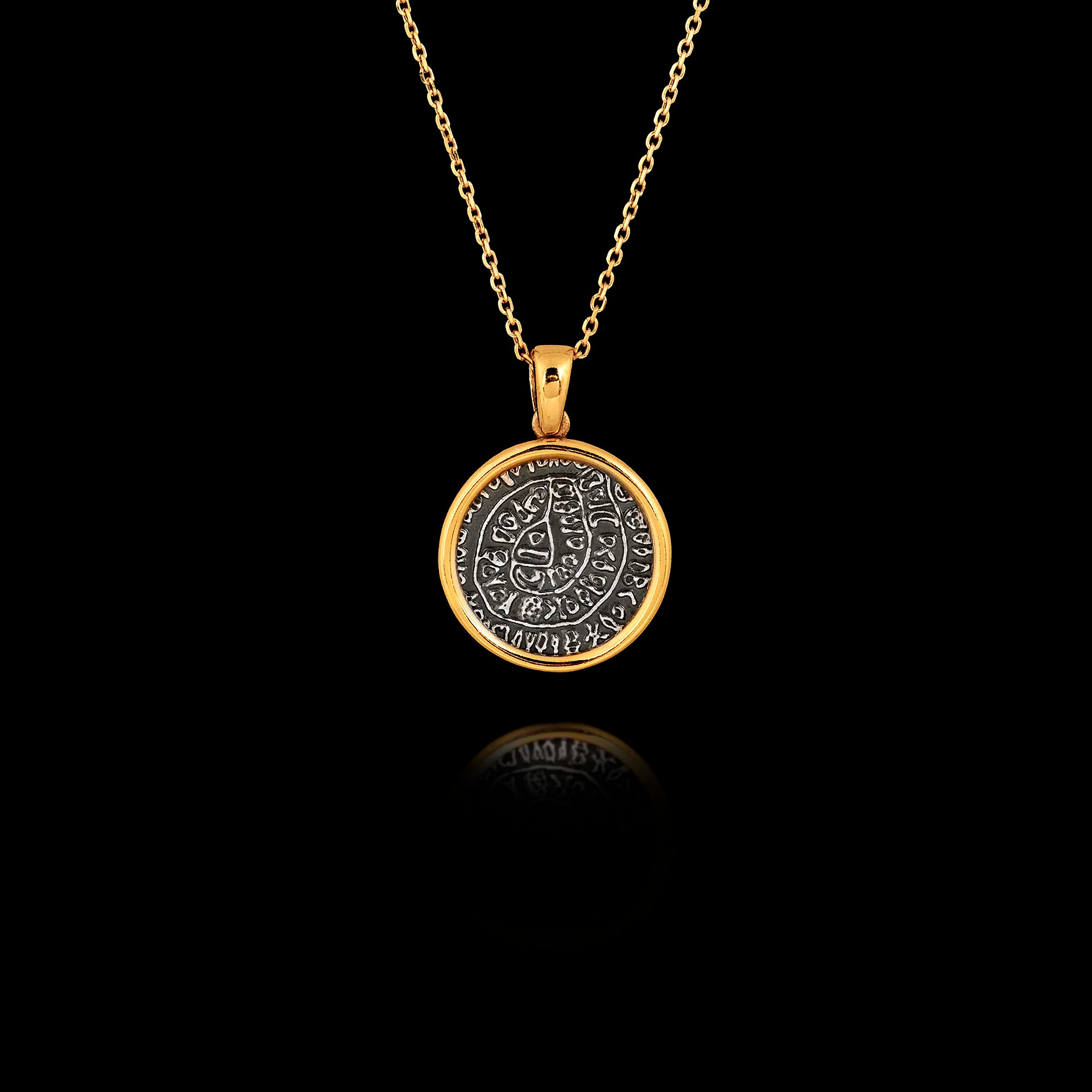 Two-tone 925 sterling silver pendant necklace featuring a gold-plated frame and an oxidized silver center depicting the symbols of the Phaistos Disc.