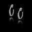 Silver open hoop earrings with clear zircon stones set along the front curve in a black background.