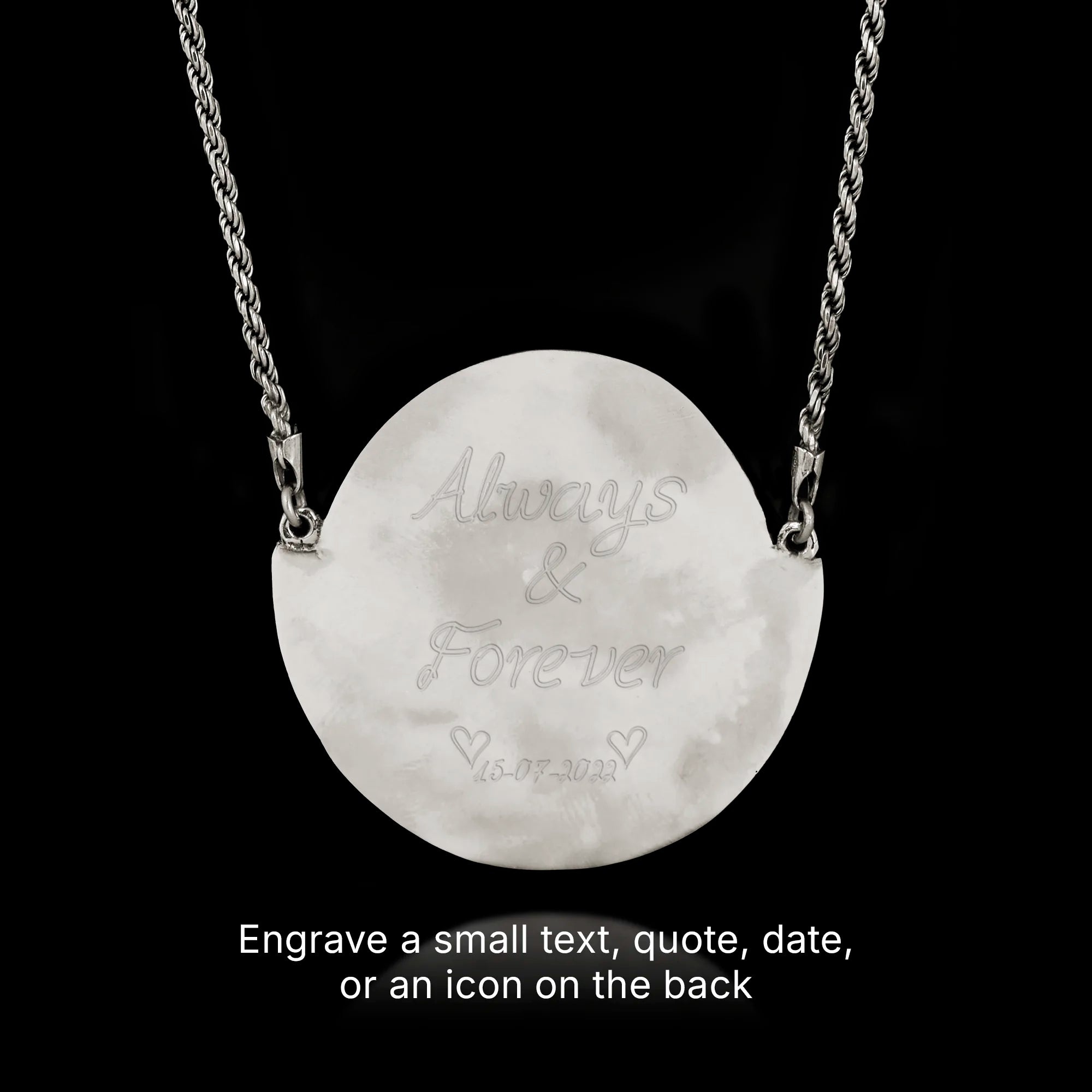 Silver necklace with a round pendant engraved with 'Always & Forever' on a black background.